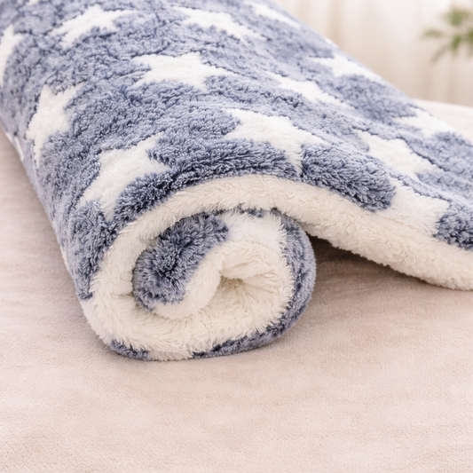 Roll of blue and white fleece Flannel Pet sleeping Mat on a beige surface