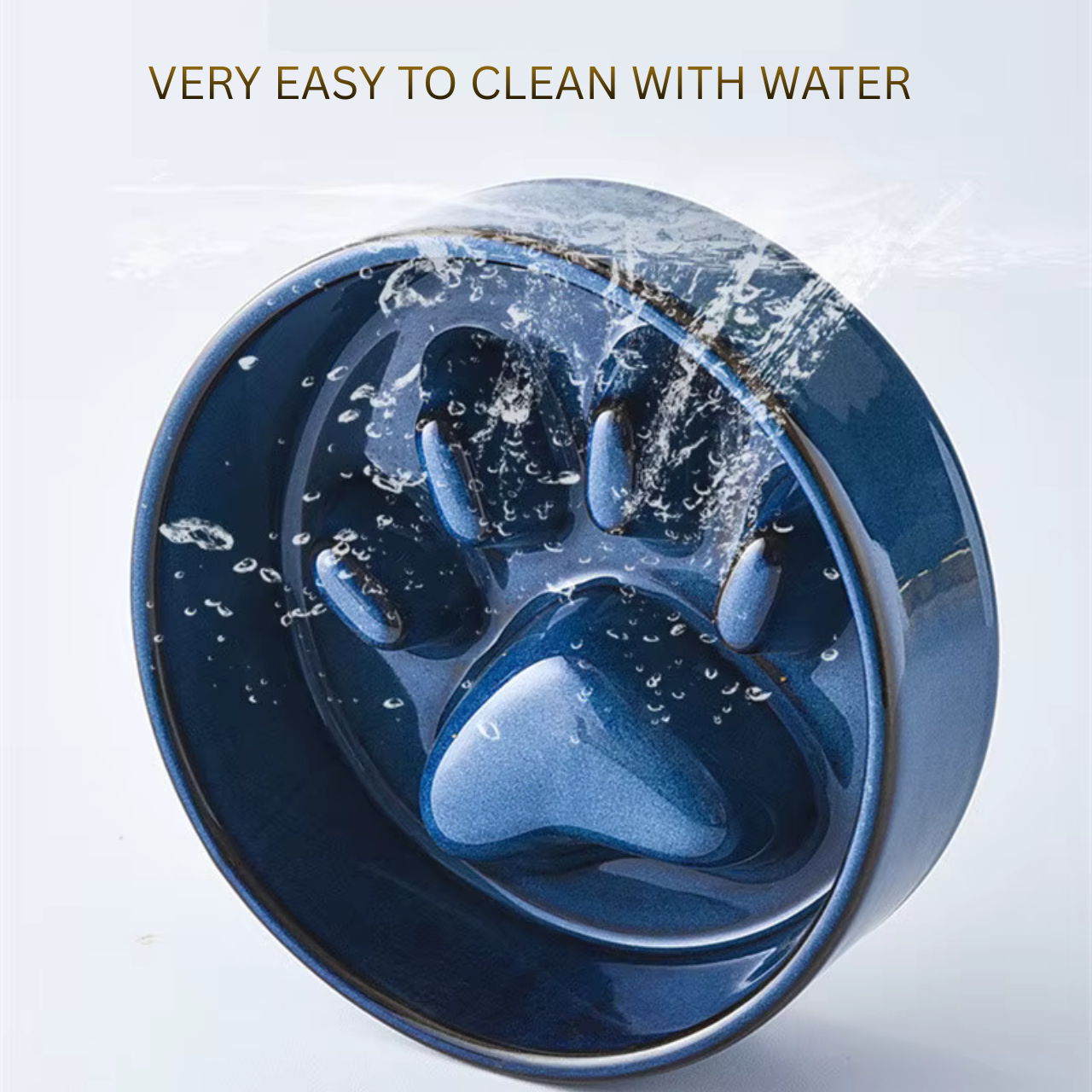 Blue ceramic slow feed bowl with water splashes on a light blue background, text 'Very easy to clean with water' above.