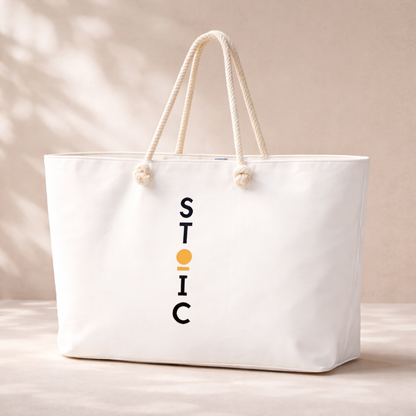 White STOIC tote bag with logo on a beige background