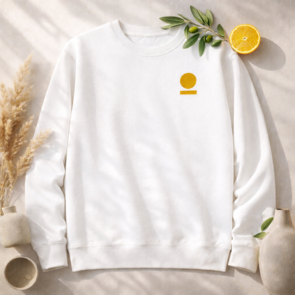 White  STOIC sweatshirt with embroidered logo on a light background with decorative elements.