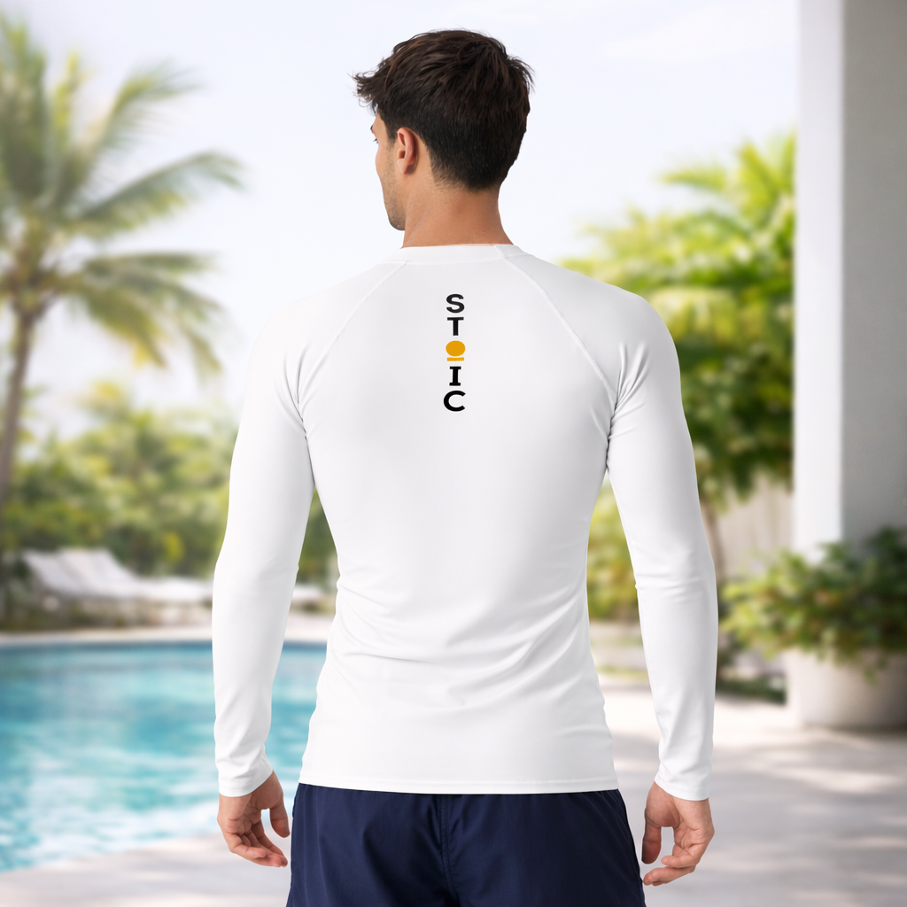 Person wearing a white STOIC long-sleeve shirt with a vertical brand logo on the back, standing by a pool with greenery in the background.