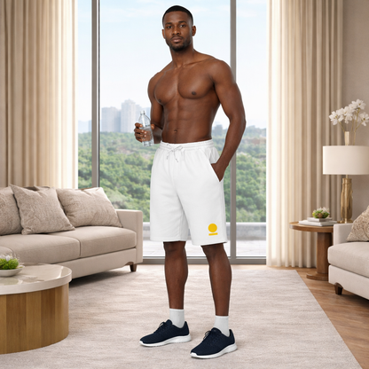Man in white STOIC shorts with embroidered logo standing in a modern living room with a cityscape view.