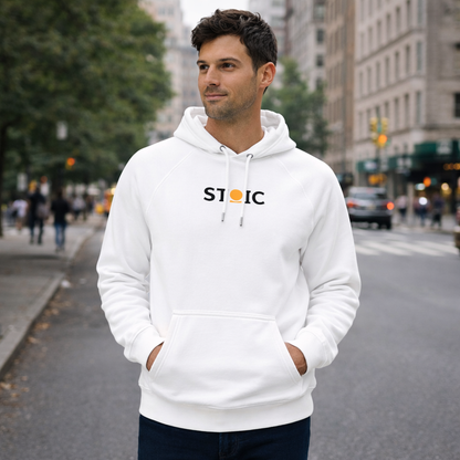 Man wearing a white STOIC hoodie with embroidered 'STOIC' logo on a city street