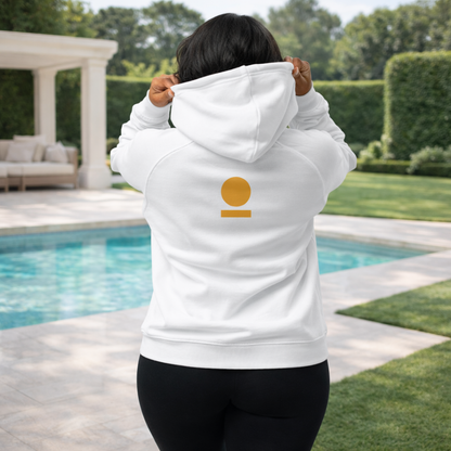 Woman wearing a white STOIC hoodie with logo on the back, outdoors by a pool