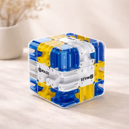 Cube-shaped puzzle toy with blue and yellow sides on a light surface