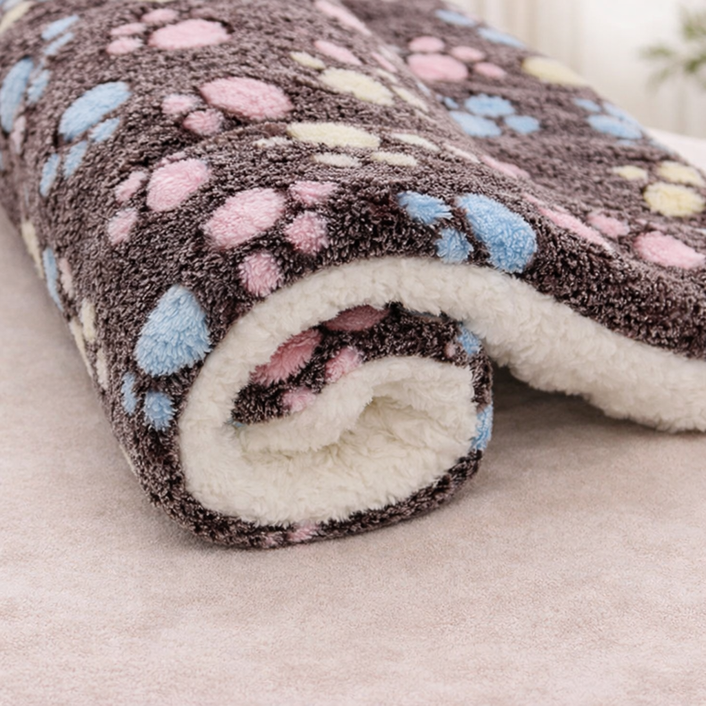 Brown Roll of fleece Flannel Pet sleeping Mat with multicolored paw prints on a neutral background