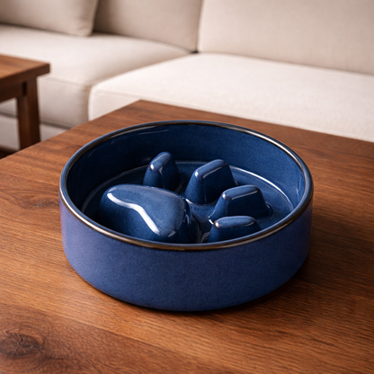 Blue ceramic slow feed bowl (no stand) with raised design on a wooden table