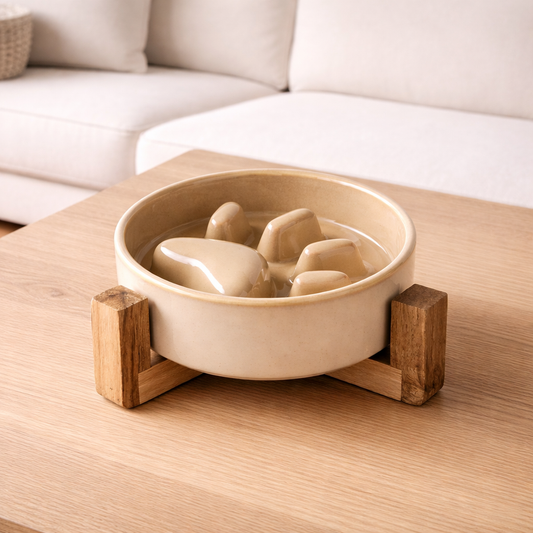 Beige ceramic  slow-feed bowl  with wooden holder on a wooden surface