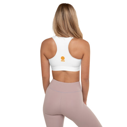Woman wearing a white STOIC sports bra with logo and pink leggings on a white background