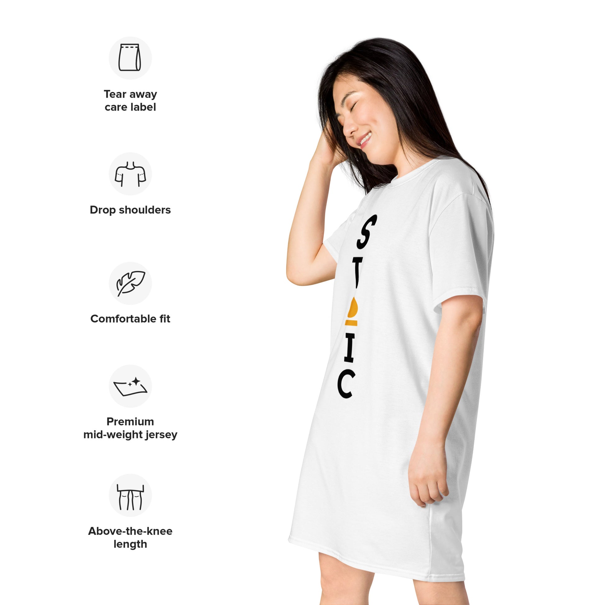“Side view of woman wearing white STOIC T-shirt dress with vertical chest logo, shown with icons highlighting tear-away care label, drop shoulders, comfortable fit, mid-weight jersey fabric, and above-the-knee length.”