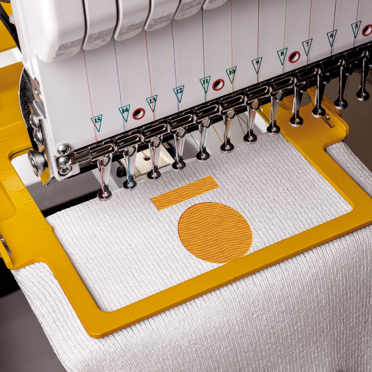 Embroidery machine in action with a piece of fabric being embroidered.